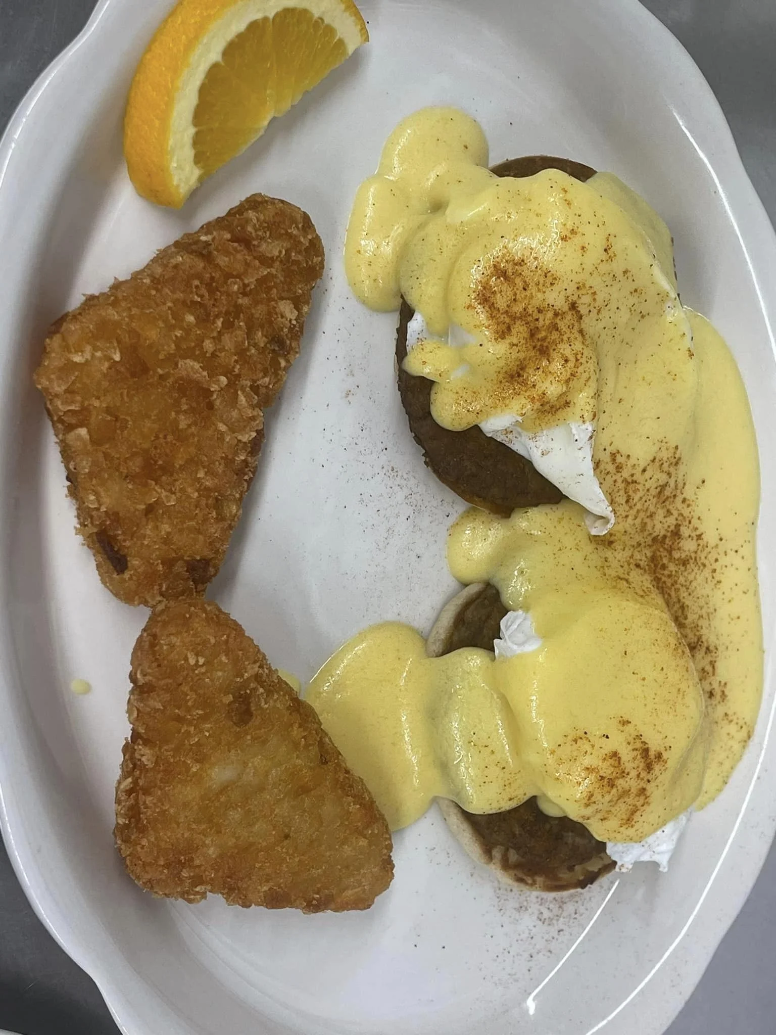 Eggs Benedict - Classic breakfast favorite with poached eggs, Canadian bacon, and rich hollandaise sauce on a toasted English muffin.