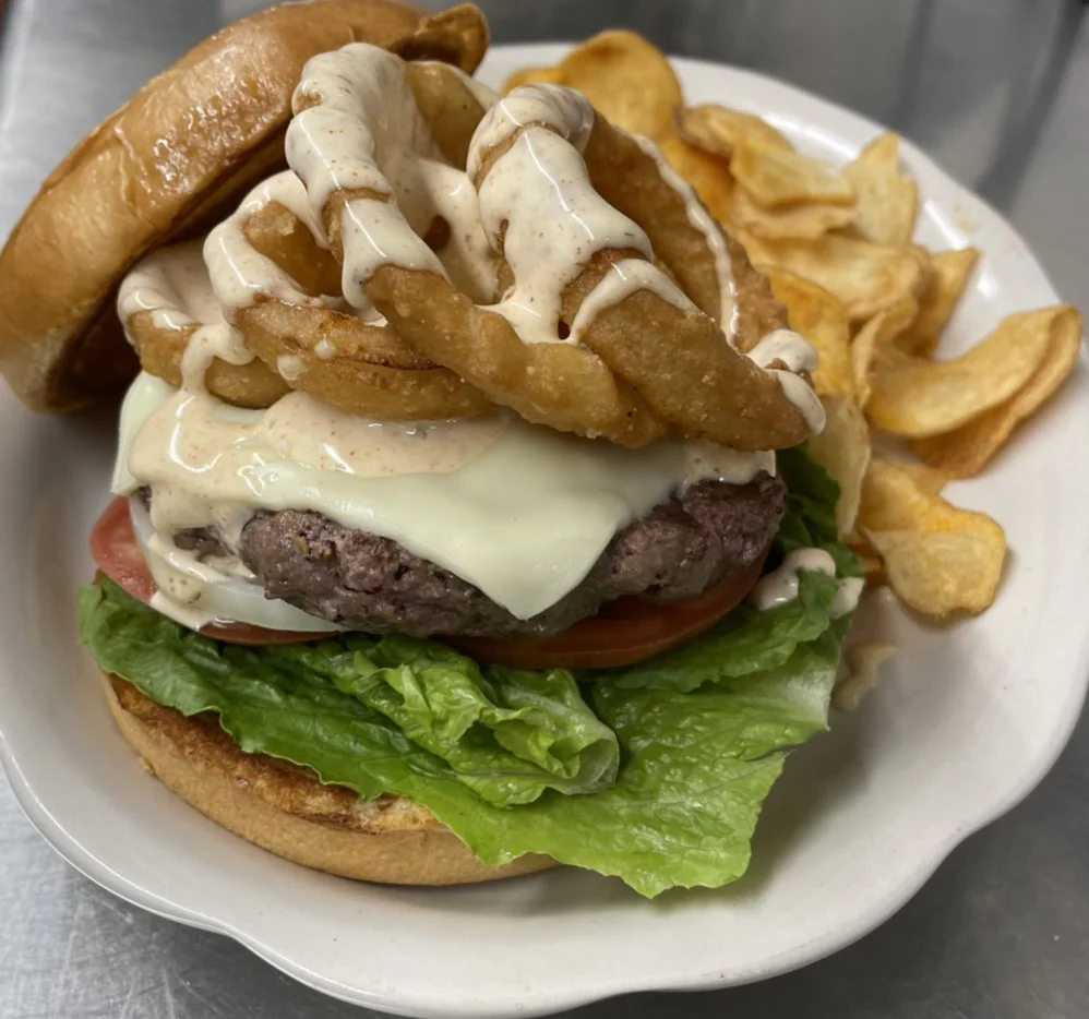 Cajun Ranch Burger - Juicy beef burger seasoned with bold Cajun spices and topped with creamy ranch dressing and fresh toppings.